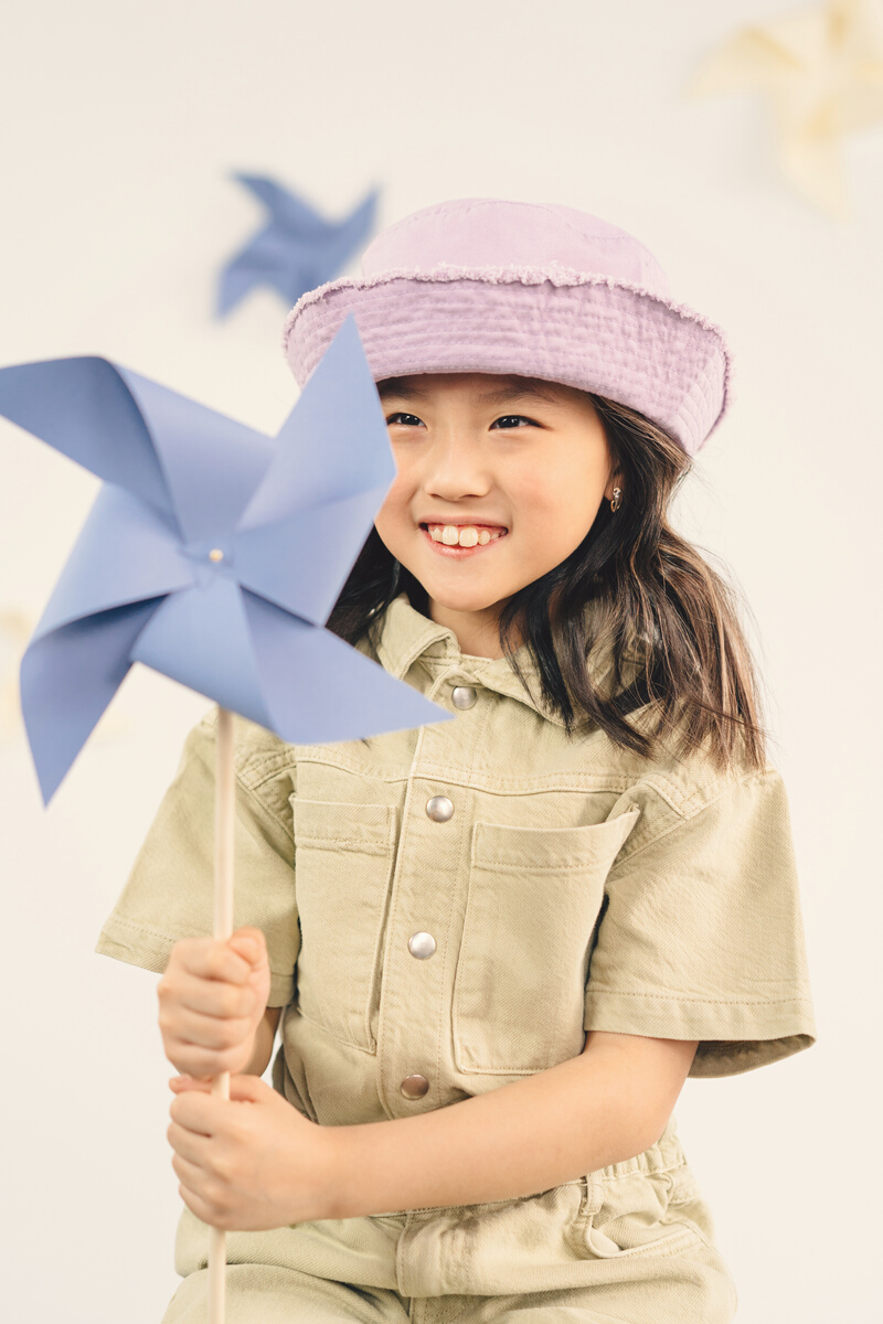 A Girl Holding a Paper Windmill